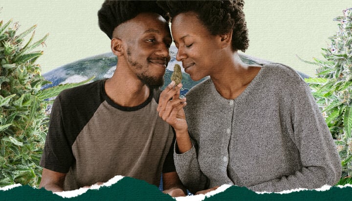 A smiling couple sitting close together with a cannabis bud between them, surrounded by lush cannabis plants and a globe in the background, creating a cozy, relaxed atmosphere.